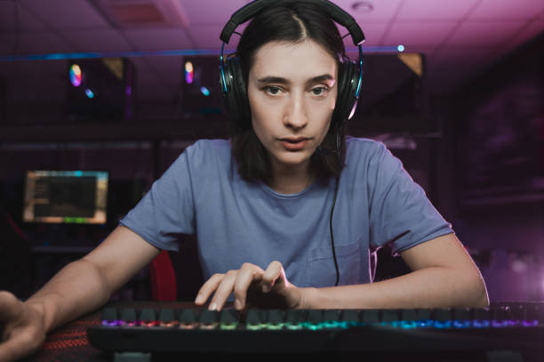 istock Female gamer playing in online video game on computer using headphones and microphone 1355657490