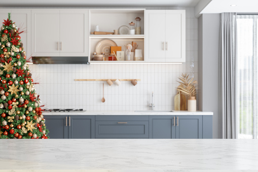 Empty White Marble Surface And Blurred Kitchen With Christmas Tree