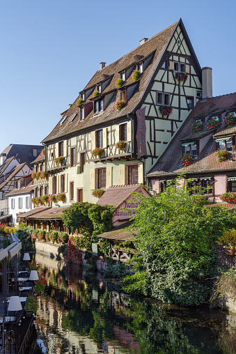 Colmar, France - October 24, 2021: Traditional Alsatian half-timbered houses along the Lauch River in Little Venice tourist district of Colmar,  Haut-Rhin department, Grand Est region of north-eastern France