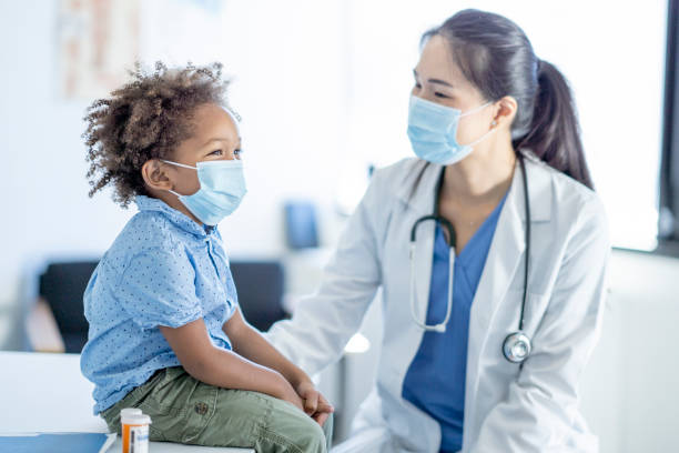 istock Doctor Talking with a Little Boy 1355662074