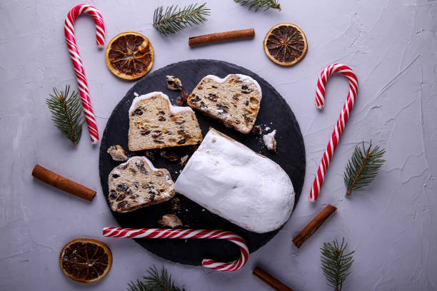istock Dresdner Stollen is a Traditional German Cake with raisins on grey background. Fruit cake for the Holiday. 1355663391