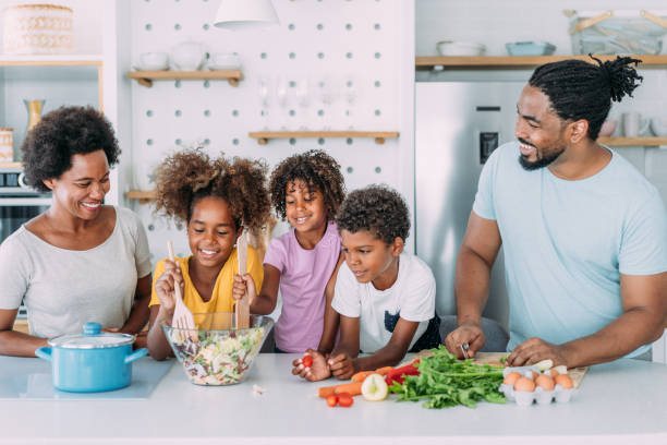 istock Happy family cooking together. 1355664436