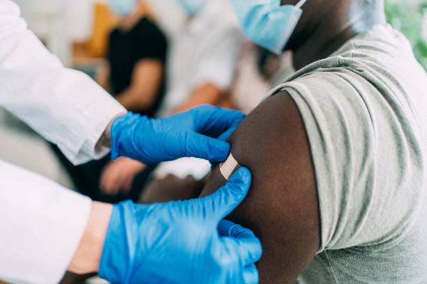 istock Doctor putting a bandage after Covid-19 vaccination. 1355664481