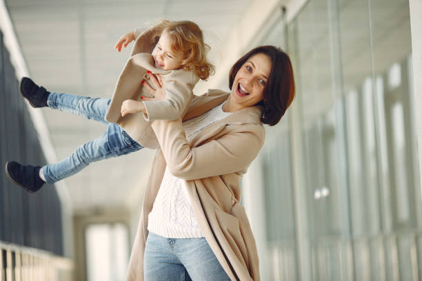istock Mother with little daughter standing in a hall 1355664887