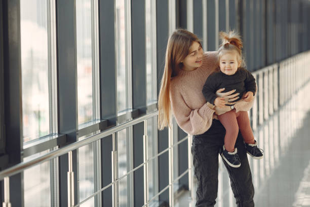 istock Mother with little daughter standing in a hall 1355665340