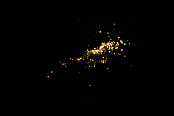 istock Golden blurred bokeh lights on black background 1355666387
