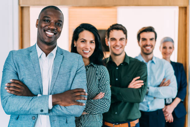 istock Confident businessman and his team. 1355666451