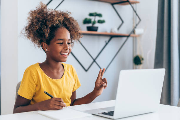 istock Cheerful girl having video call at home. 1355666520