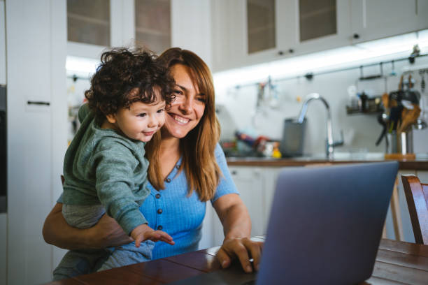 istock Mother and little son working at home. 1355666661