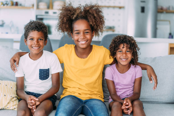 istock Three adorable little children having fun together at home. 1355666710