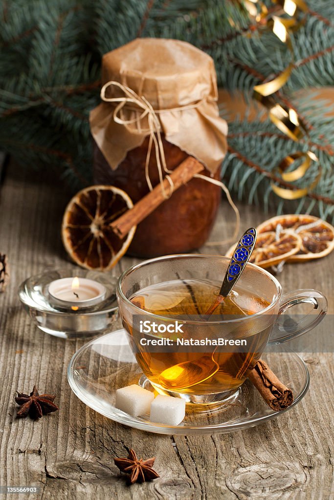 Christmas tea Hot winter tea with cinnamon stick, sugar and jar of jam on old wooden table Anise Stock Photo