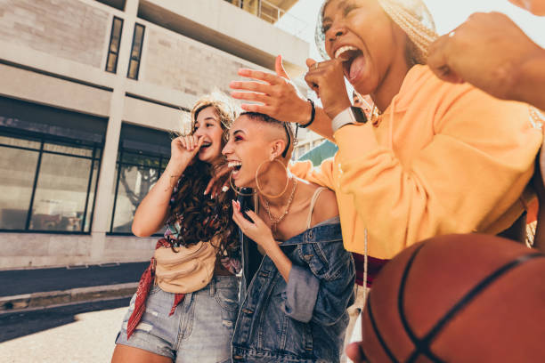 istock Friends laughing together outdoors 1355670029
