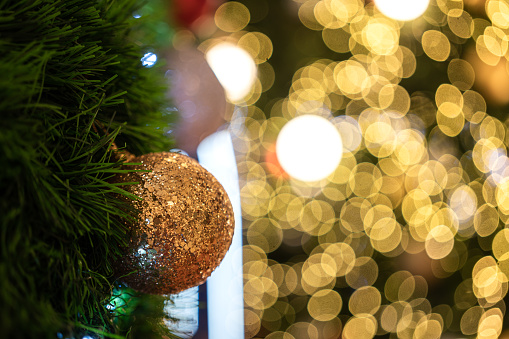 Decorated Christmas tree on bokeh lighting blurred background. Interior decor and background photo.