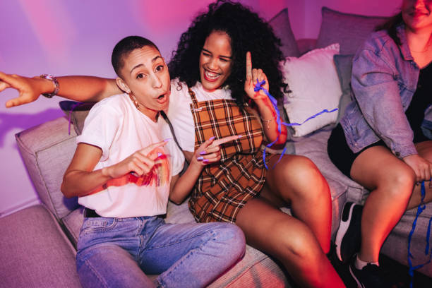 istock Girlfriends dancing at a house party 1355672419