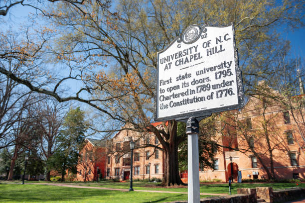 UNC Chapel Hill, NC, USA Chapel Hill, NC, USA - April 28, 2015: UNC Chapel HIll campus and sign claiming “the first state university to open its doors.” chapel hill photos stock pictures, royalty-free photos & images