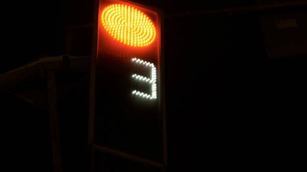 istock Traffic light red counting down. The night is winter it is snowing 1355676476