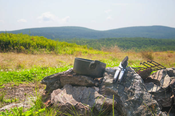 istock cooking pot and can opener at a campsite 1355677703