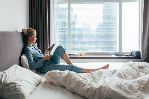 istock A Side View Of A Blonde Female Texting And Smiling 1355681623