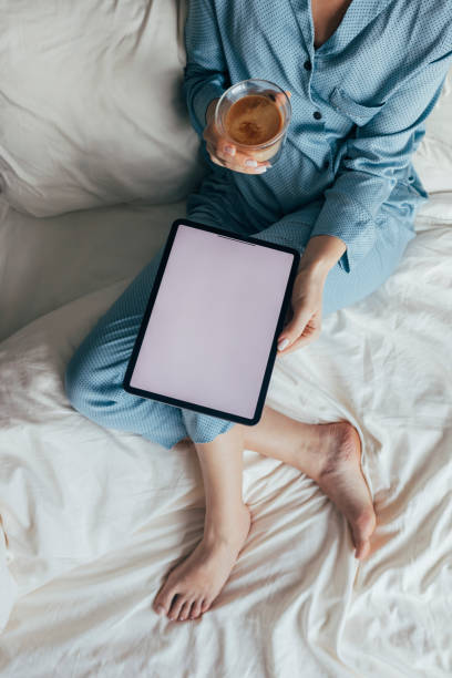 istock A Businesswoman Sitting On Her Bed  And Reading Reports 1355681651