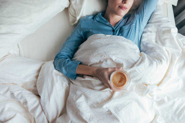 istock An Unrecognizable Woman Drinking Coffee In Bed 1355681655