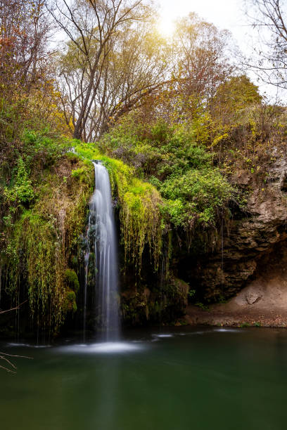 istock Beautiful waterfall Bourbon with a lagoon in the autumn forest. 1355681787