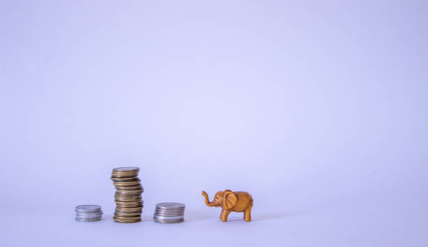 istock Tower of golden coins on white background 1355681973