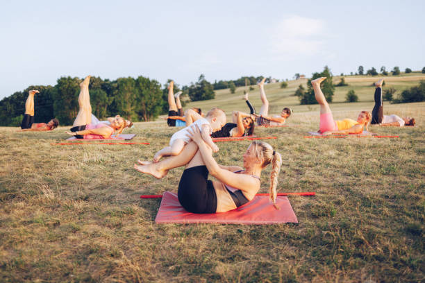 istock Group of women attending yoga class outdoors 1355683094