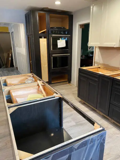 Photo of New cabinets and island installed in a kitchen under renovation construction