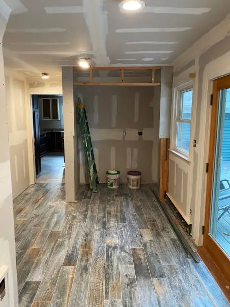 Photo of New tile floors and spackled walls in home under construction renovation