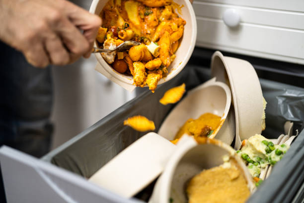 istock Throwing Away Leftover Food In Trash 1355684612