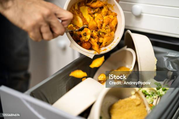 Throwing Away Leftover Food In Trash Stock Photo - Download Image Now - Garbage, Food, Throwing