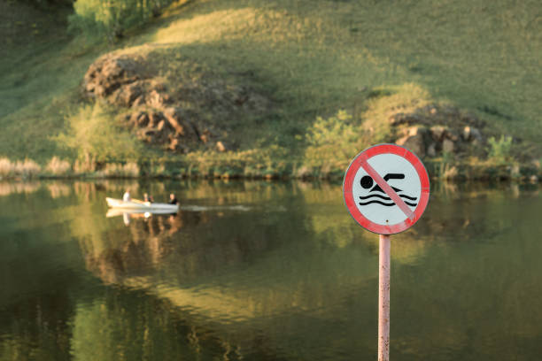 istock summer day on the river, swimming is prohibited sign 1355684984