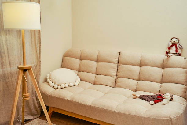istock A lonely abandoned plush toy hare on an empty sofa without people 1355685776
