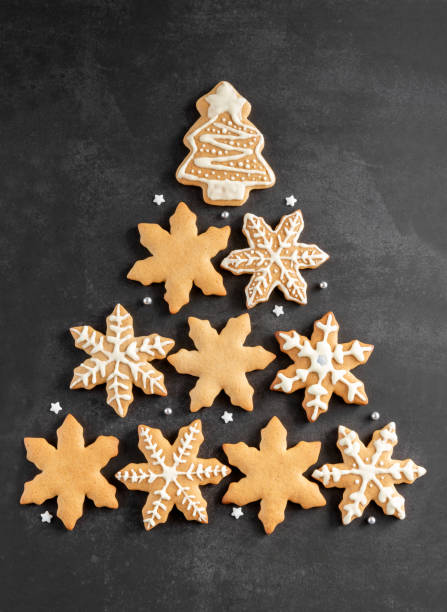 istock Christmas tree made of gingerbread on a dark background. New Year card 1355687628