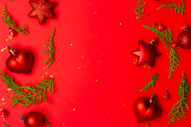 istock Christmas composition with decorations and ornametns on red background 1355688783
