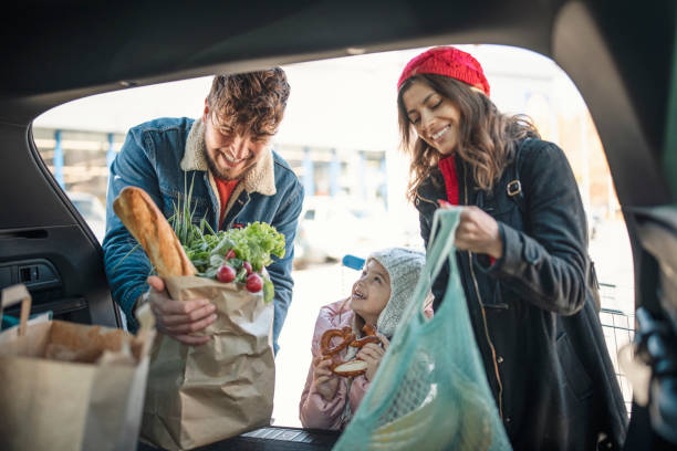 Sweet Family Loading Groceries In Trunk