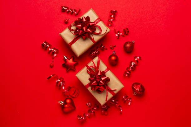 istock Christmas composition with decorations and ornametns on red background 1355688883