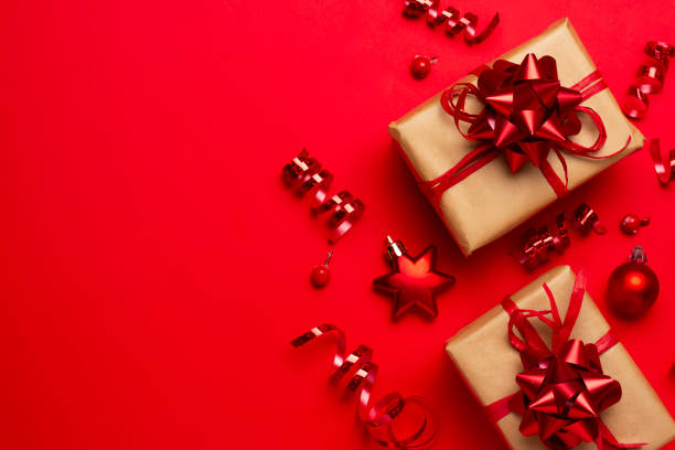 istock Christmas composition with decorations and ornametns on red background 1355688936