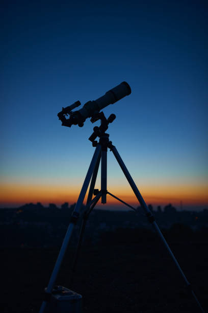 istock Astronomical telescope under a twilight sky ready for stargazing. 1355689054