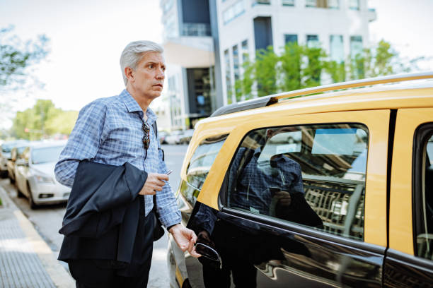 istock Latino businessman using taxi 1355691210