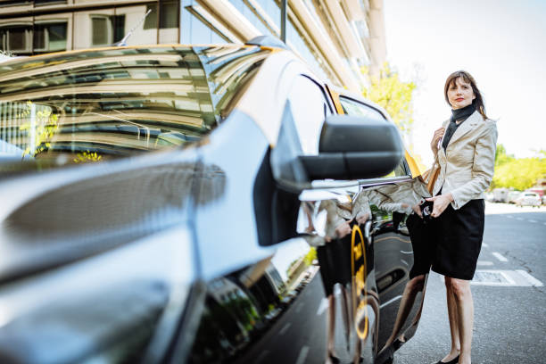 istock Latino businesswoman using taxi ride from work 1355691239