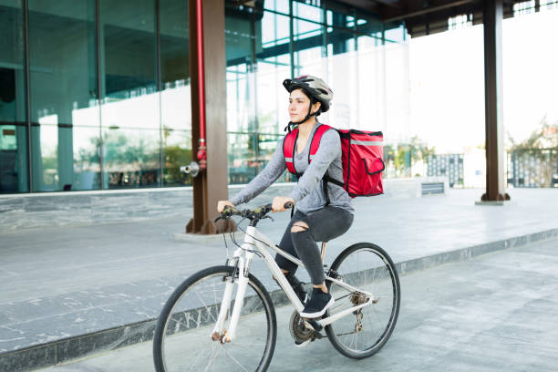 istock Beautiful delivery person on the bicycle 1355692107