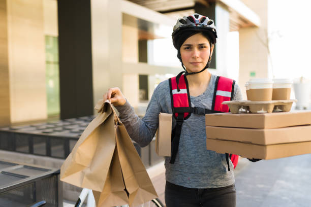 istock Stressed courier with a lot of food 1355692437