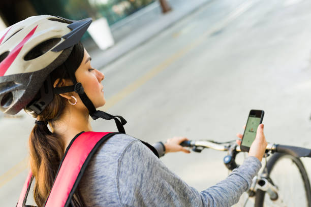 istock Focused delivery person riding a bicycle 1355693383