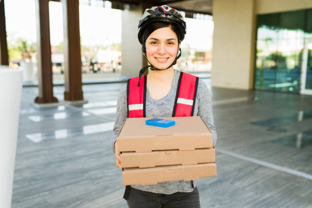 istock Young woman delivering pizza 1355693436