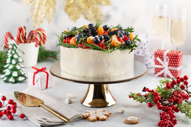 istock Christmas white cake decorated with fresh fruits, berries, 1355693562