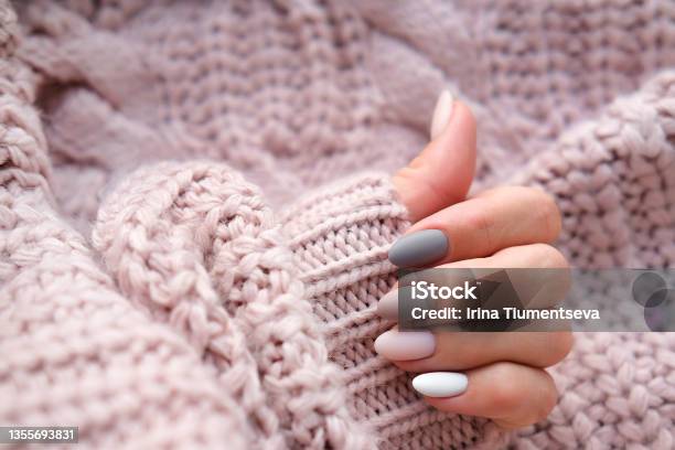 Womens Hands With A Beautiful Matte Oval Manicure In A Warm Knitted Sweater Winter Trend Polish Beige Nails With Gel Polish Shellac Copy Space Stock Photo - Download Image Now