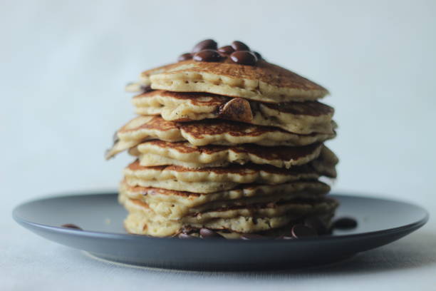 istock Stack of Oats Choco chips pancakes along with coffee for breakfast. Healthy pancakes made of oats flour loaded with chocolate chips 1355696073