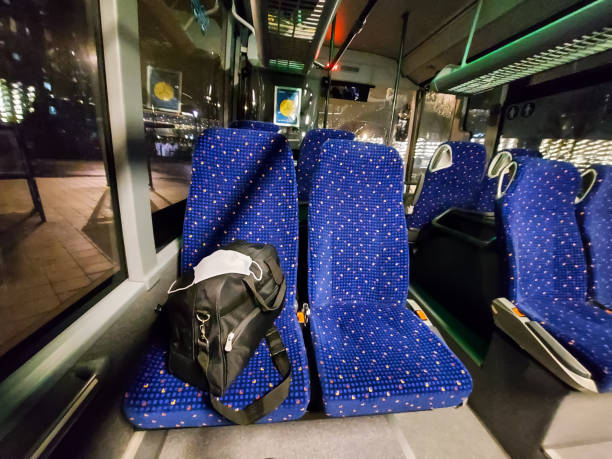 istock Luggage with protective masks stands on a seat in the bus 1355698043