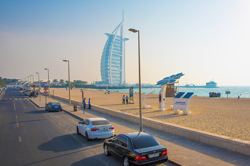 Burj Al Arab, Dubai, United Arab Emirates - November 26, 2021; The Burj Al Arab is a luxury hotel located in the city of Dubai. Burj Al Arab stands on an artificial island that is 280 m (920 ft) from Jumeirah Beach and is connected to the mainland by a private curving bridge. The shape of the structure is designed to resemble the sail of a ship. It has a helipad near the roof, at a height of 210 m (689 ft) above ground.